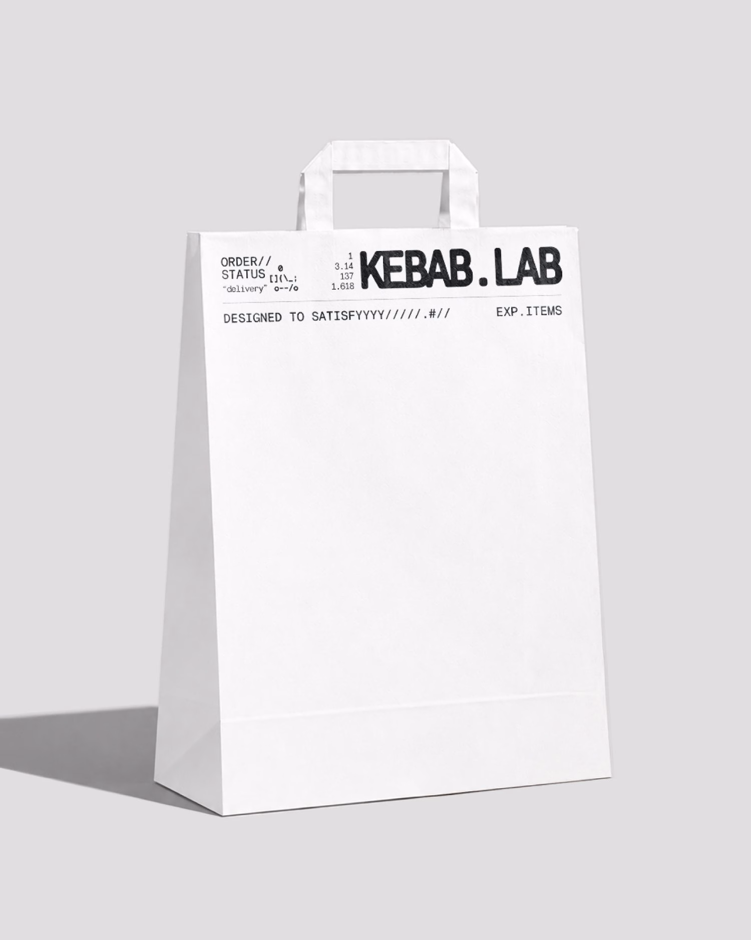 White paper bag featuring bold black typography for KEBAB.LAB, highlighting modern, minimalist packaging design.