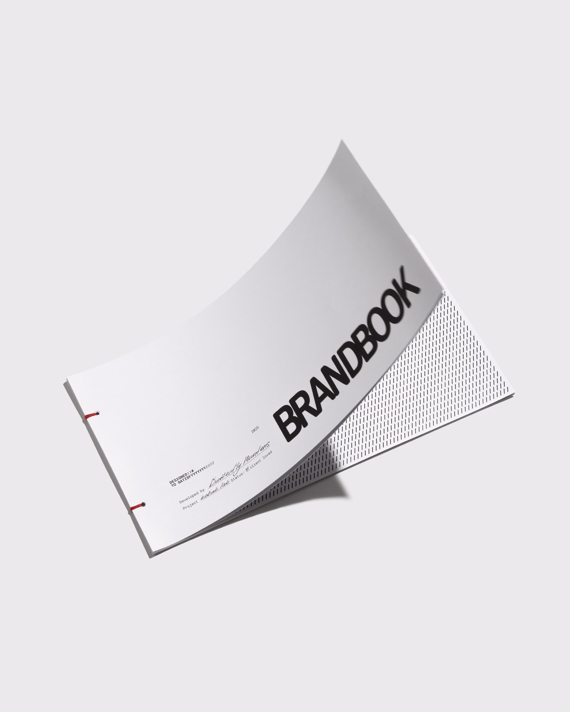 A curved brandbook with bold black typography on a white cover, showcasing a minimalist design aesthetic.