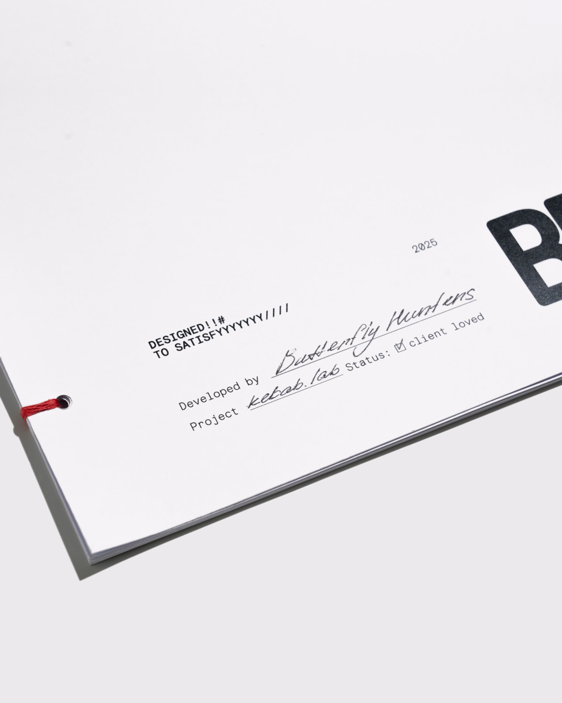 A close-up of a white page with bold black typography and handwritten notes, showcasing branding for Kebab.Lab.