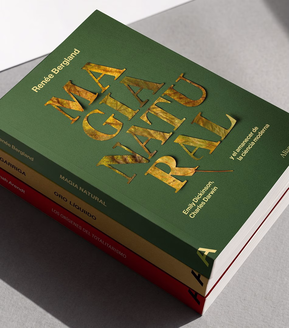 Book cover design featuring a green background with bold, golden typography for "MAGIA NATURAL" and layered colorful books.