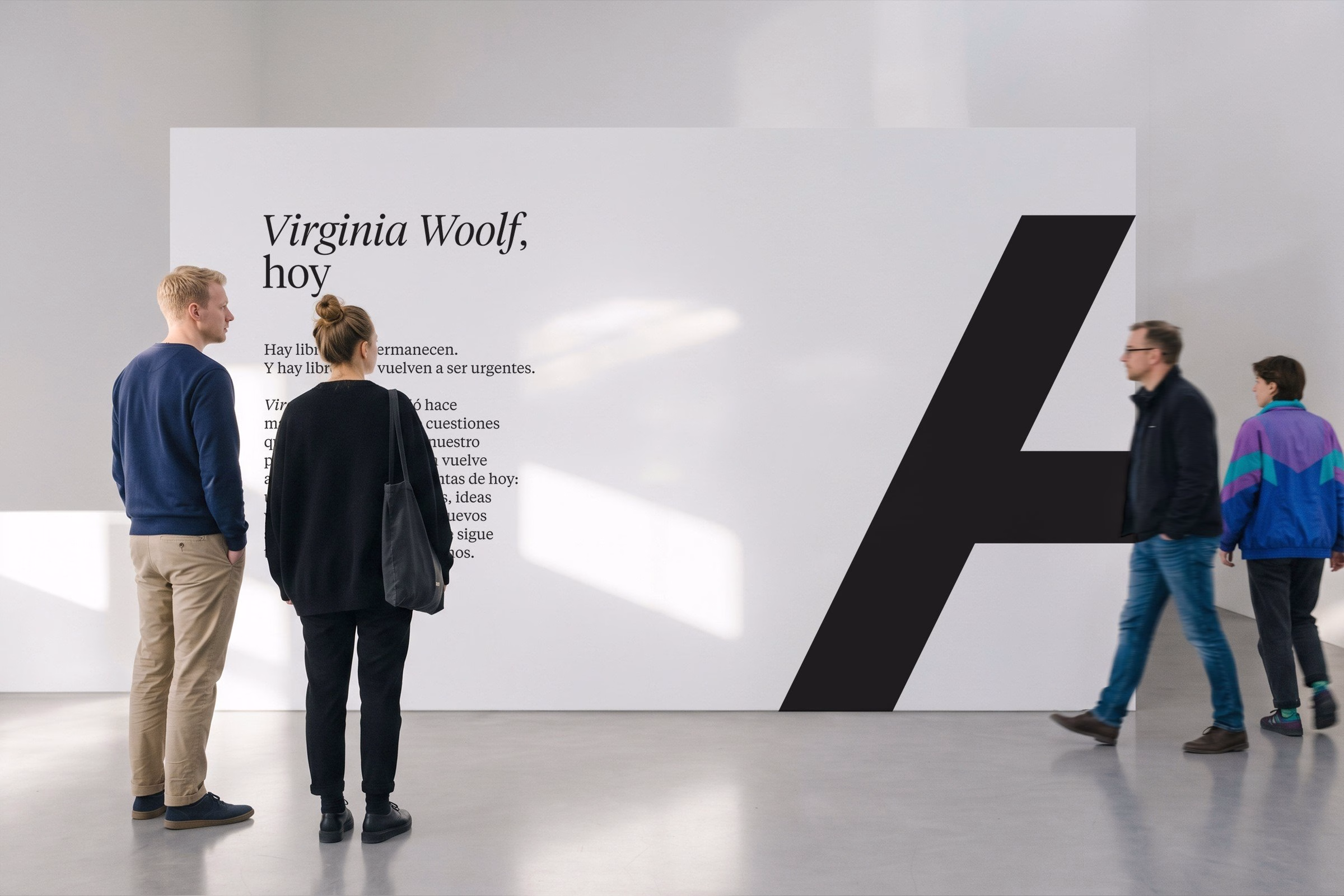 Visitors observe a large white wall featuring bold black typography, showcasing the project for Alianza's cultural branding.