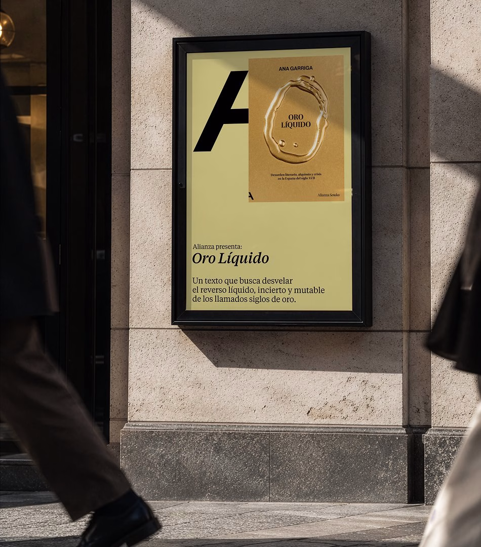 A street view of a poster showcasing "Oro Líquido" book cover, featuring bold typography on a light background.