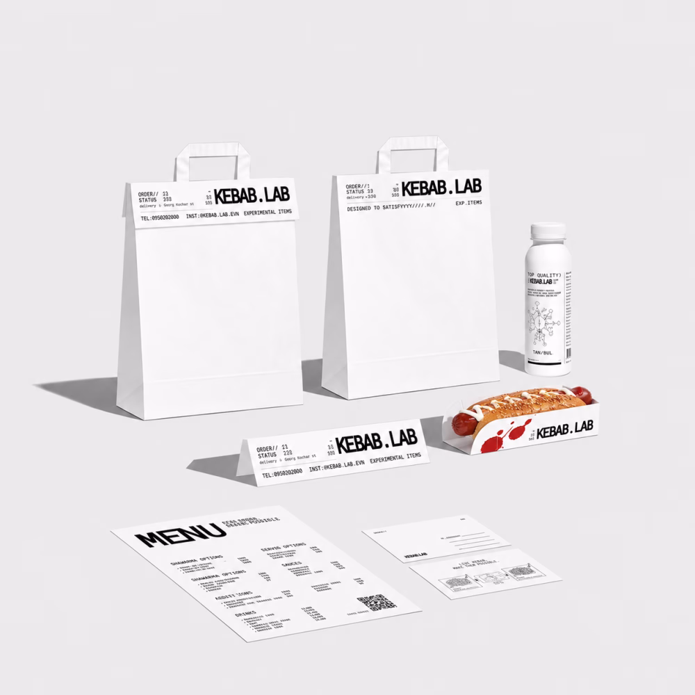 White packaging and branding for Kebab.Lab displayed with a menu, a drink, and a kebab in a minimalist layout.