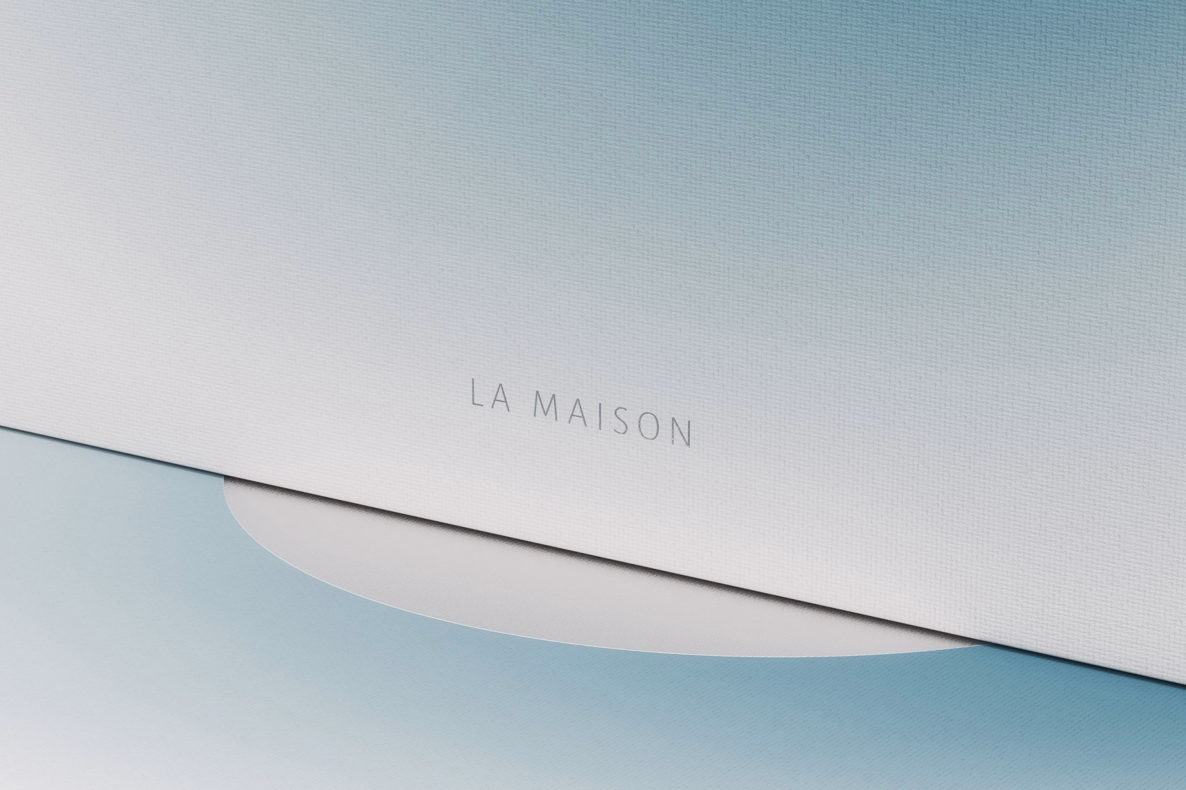 Corner of a white LA MAISON mooncake box with a blue gradient moon edge, House of Ta Studio packaging