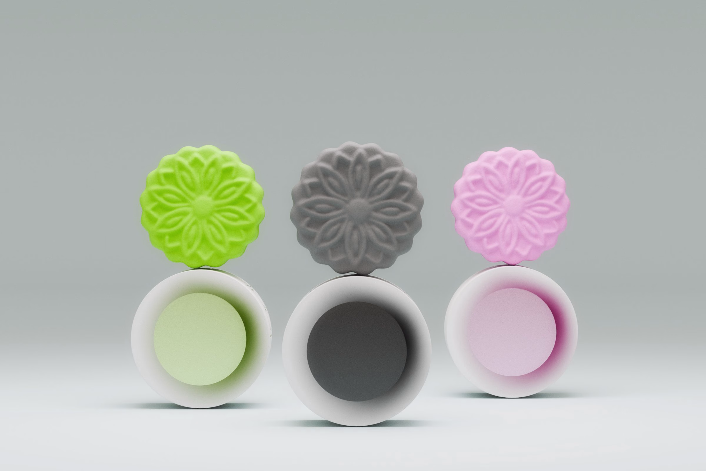 Green, charcoal and pink mooncakes above their open tins, LA MAISON packaging