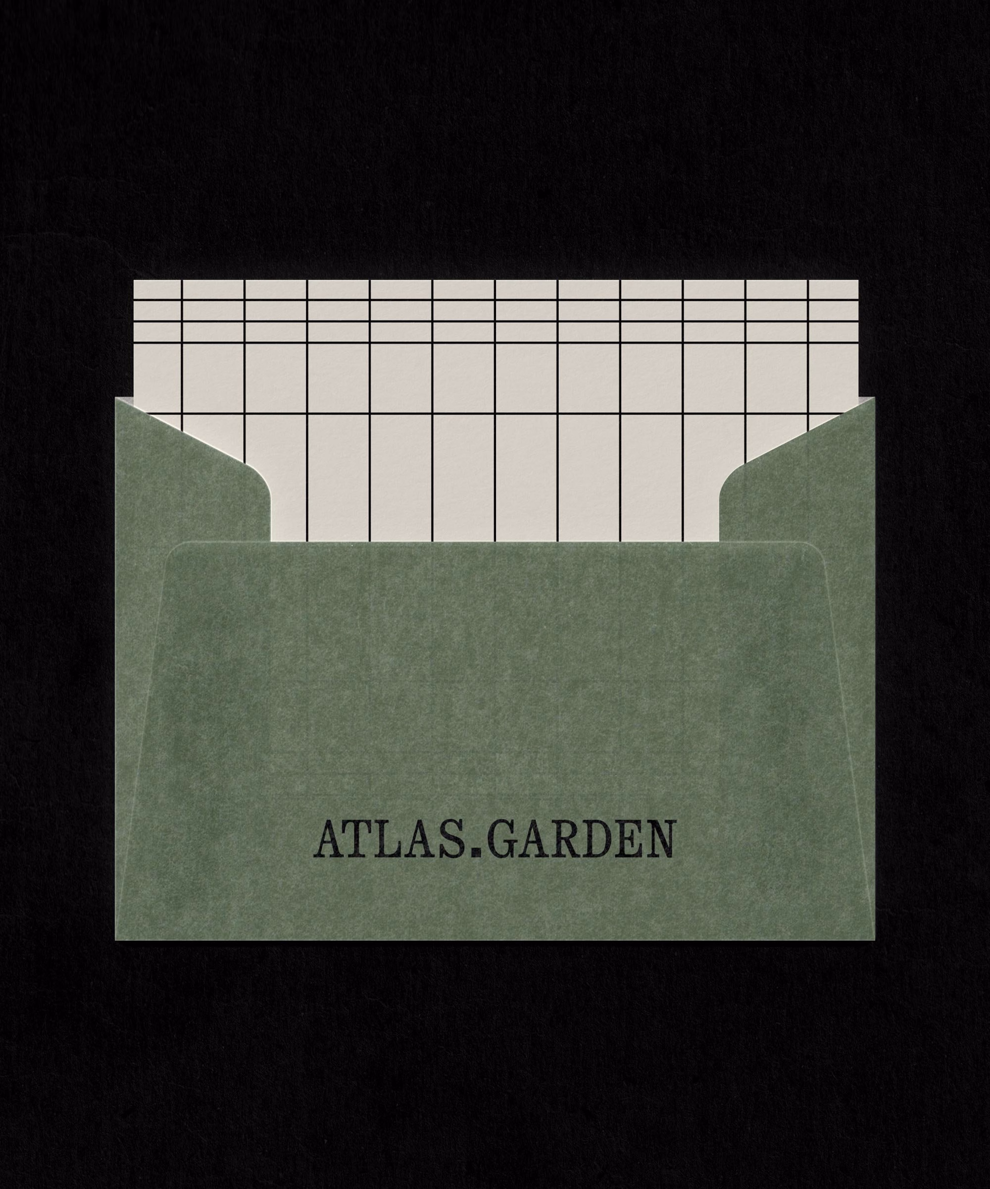 A lichen green folder with "ATLAS.GARDEN" printed in bold black typography, revealing a grid pattern sheet inside.