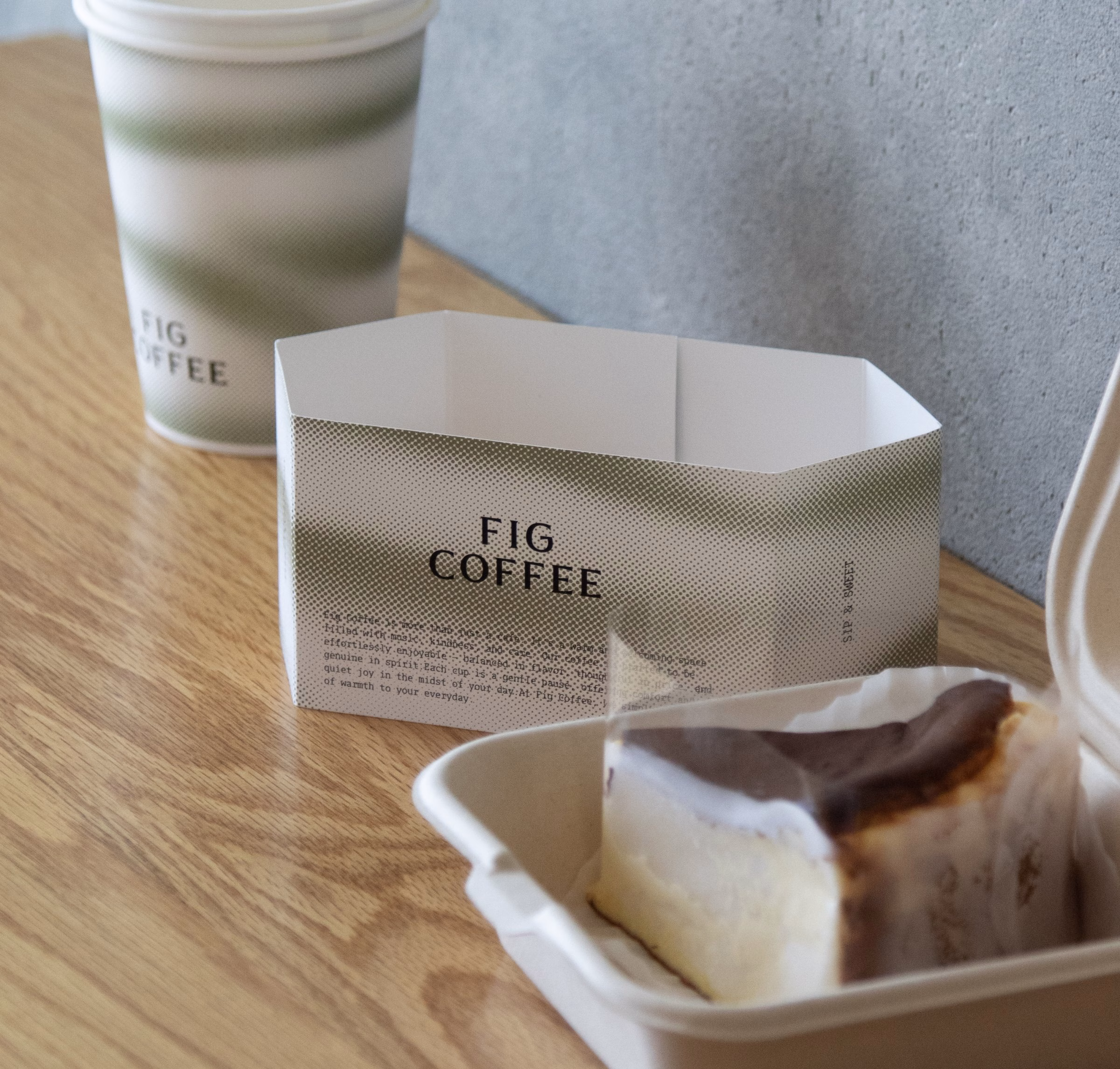 Fig Coffee cake box with a gradient sleeve beside a slice of cheesecake