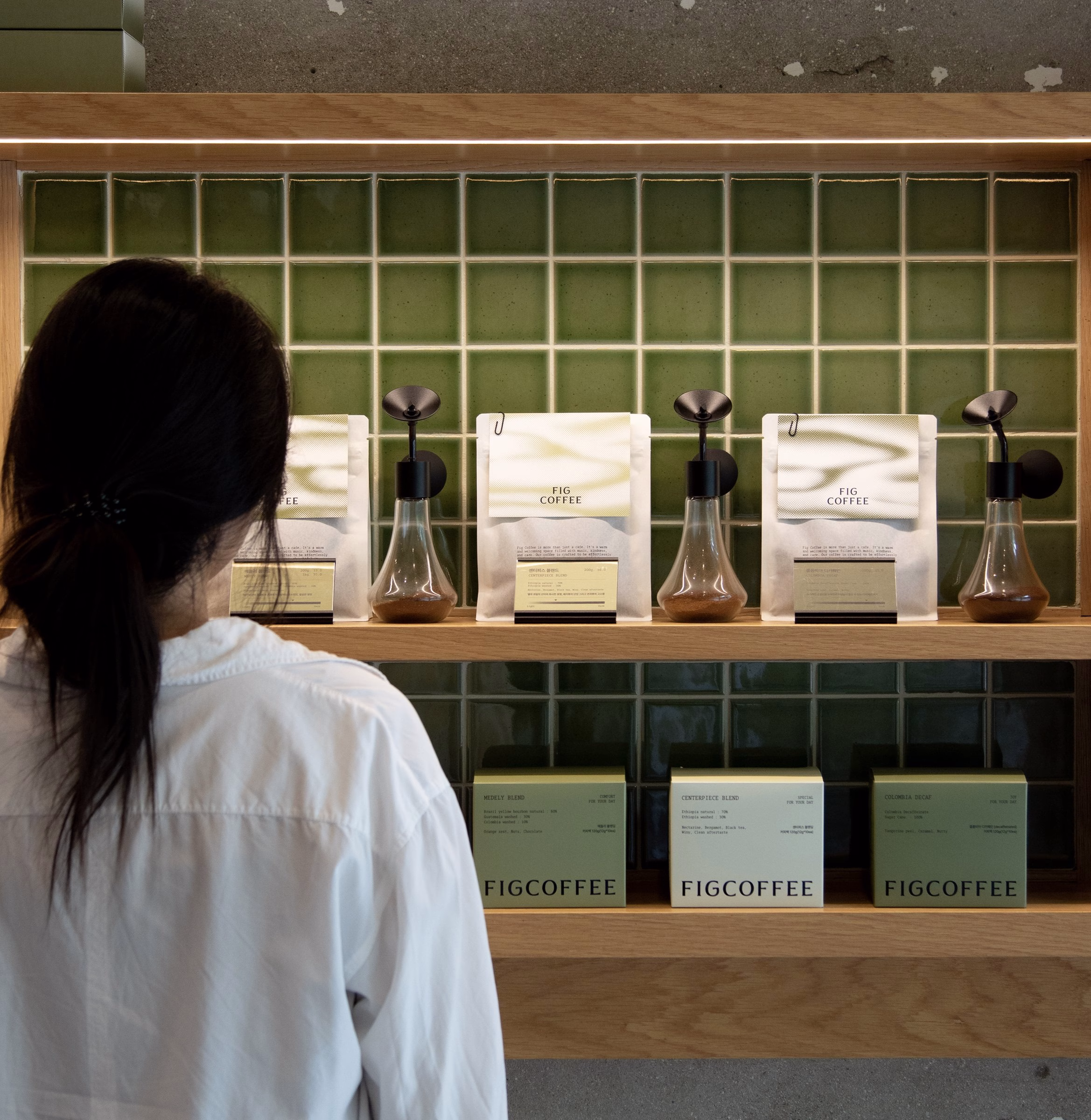 Fig Coffee retail shelf with white bean bags in front of green tiles