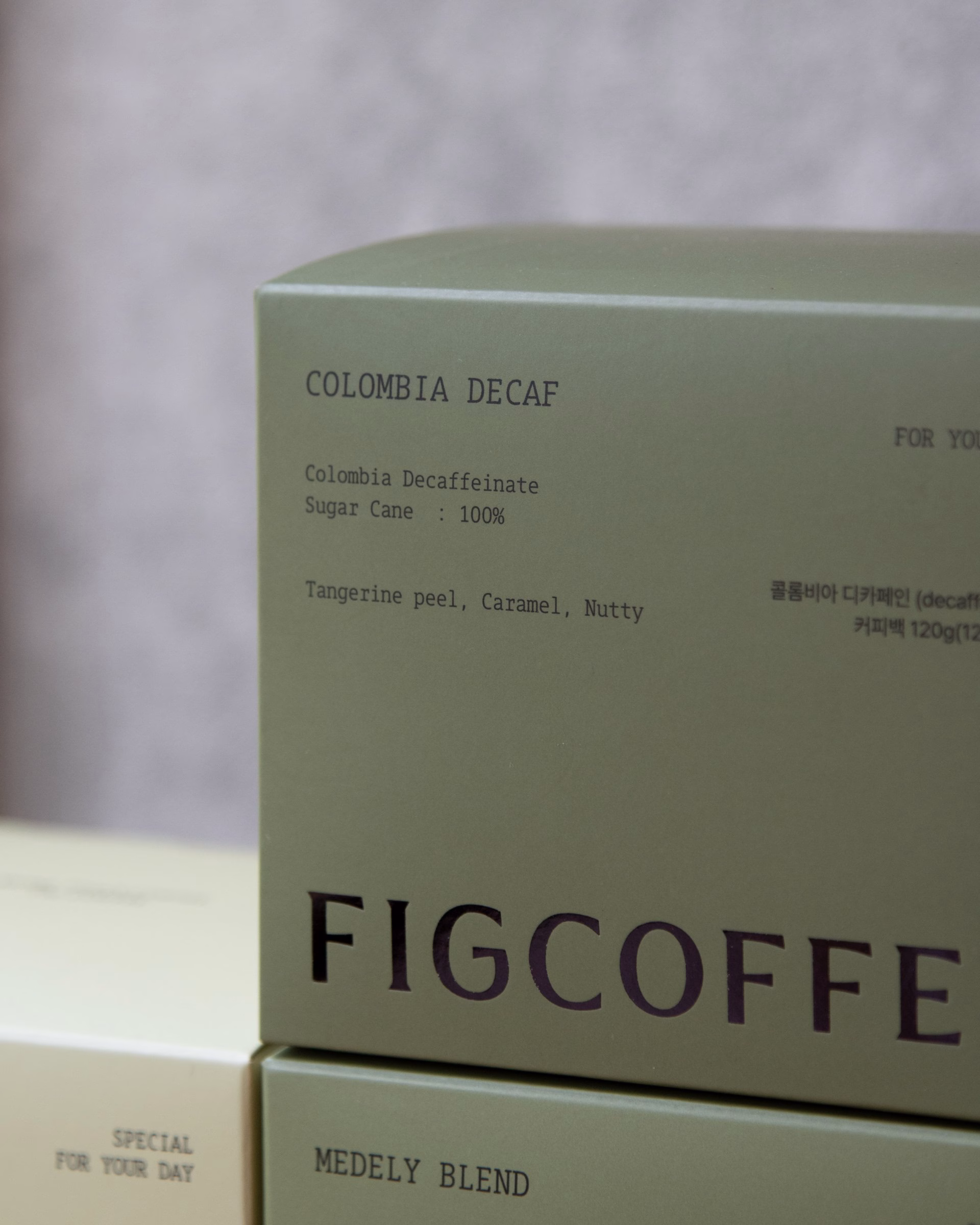 Large green FIGCOFFEE carton with product details, coffee packaging system