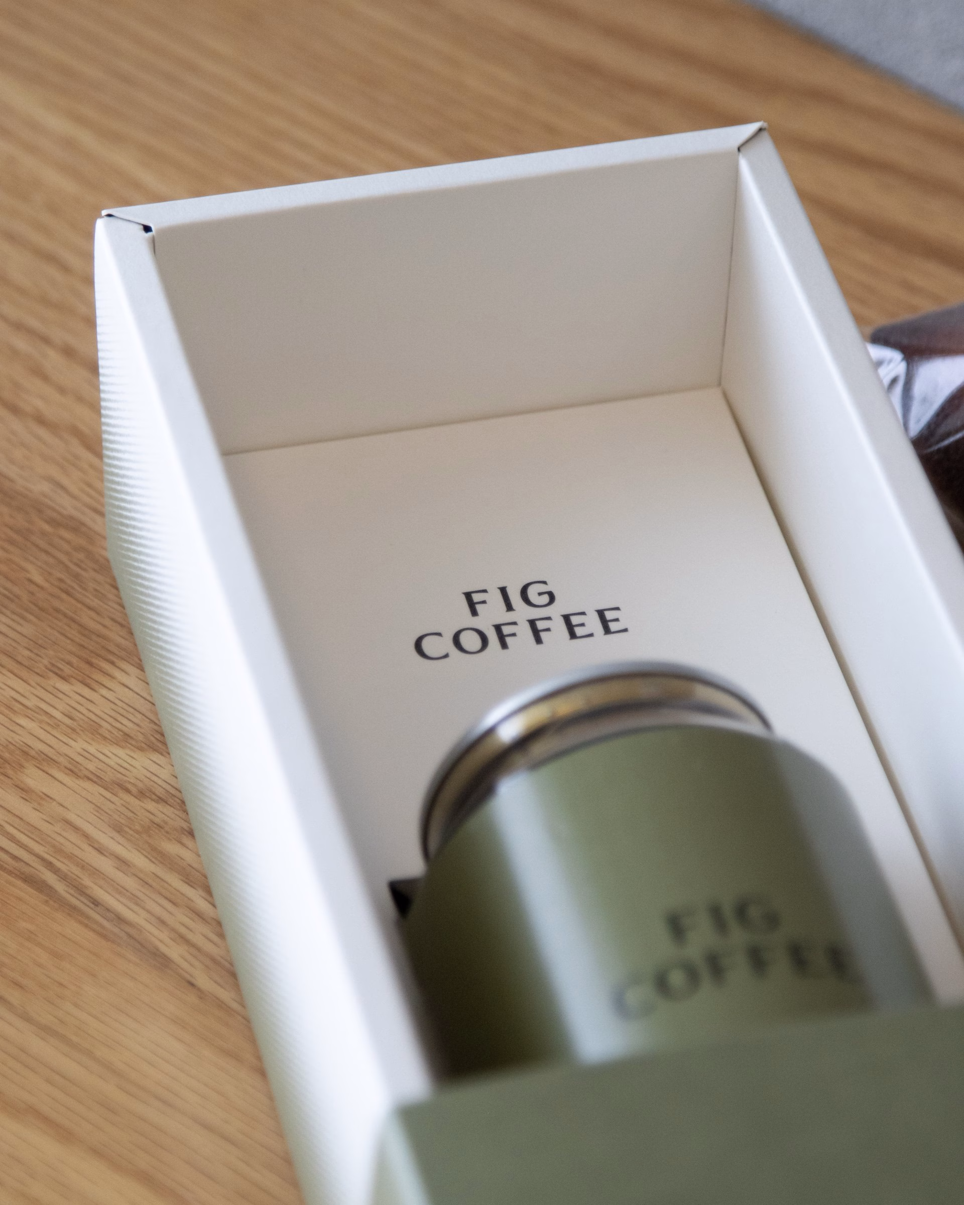 Green Fig Coffee can sitting in an open white gift box