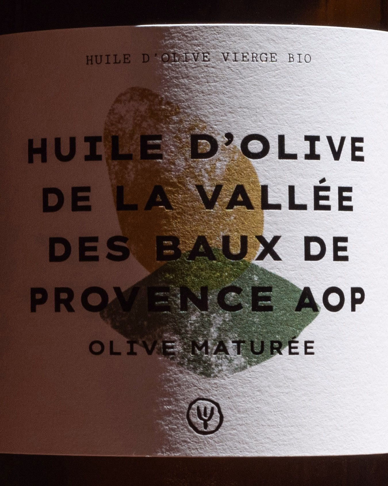 Label featuring bold typography and earthy tones, showcasing Provençal olive oil branding.